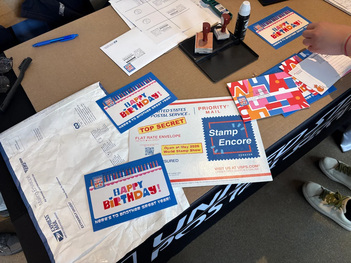 The Stamp Encore secret envelop on a table with Happy Birthday stamp cards.